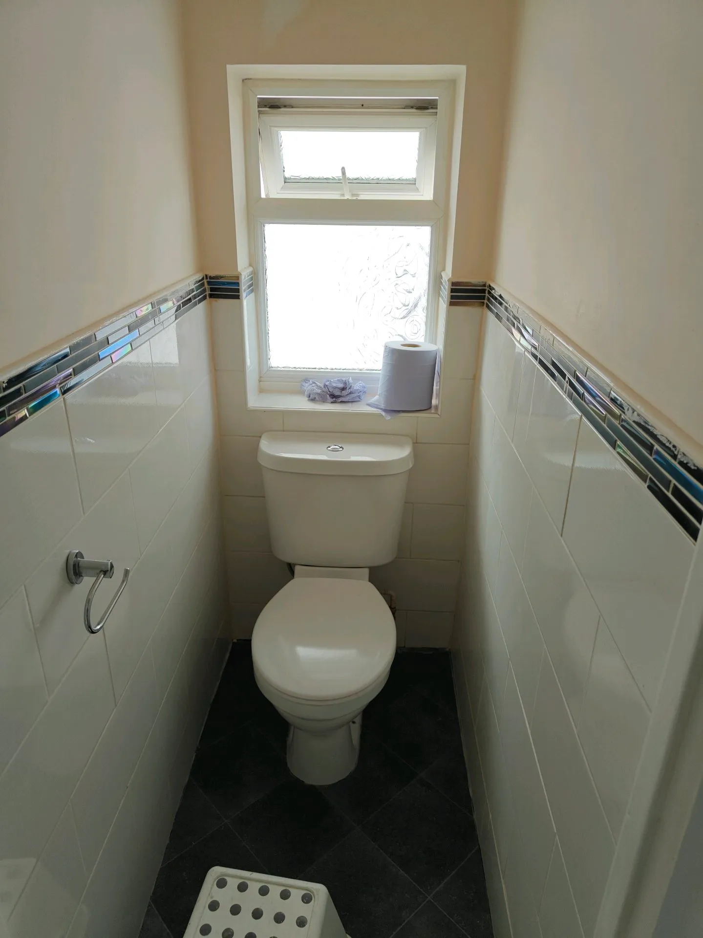 Before: a tired bathroom with an old suite and damaged wall tiles