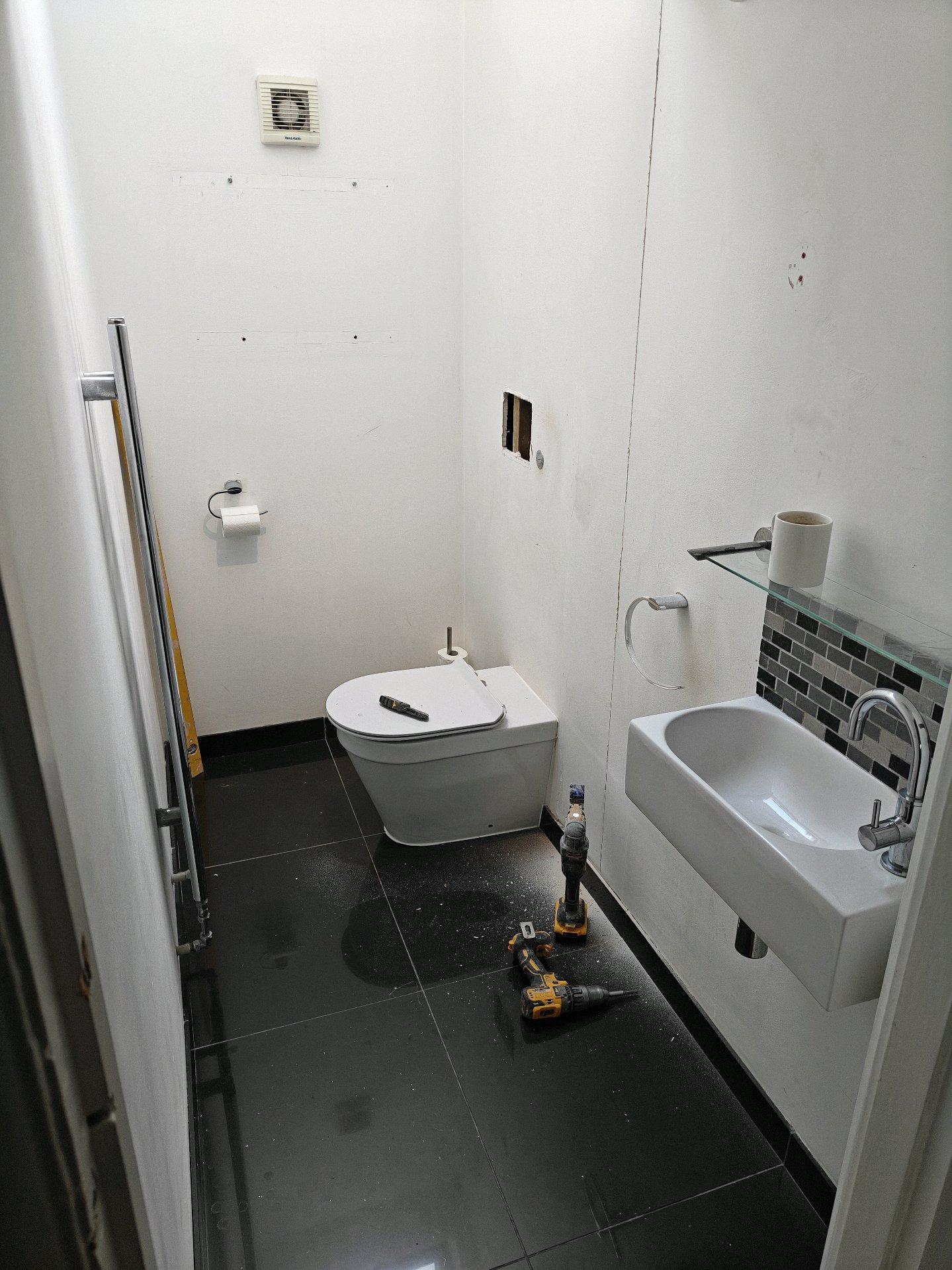 During: Cloakroom mid-renovation with new toilet and basin fitted