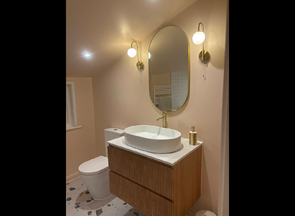 Luxury bathroom with brass fixtures and wood vanity