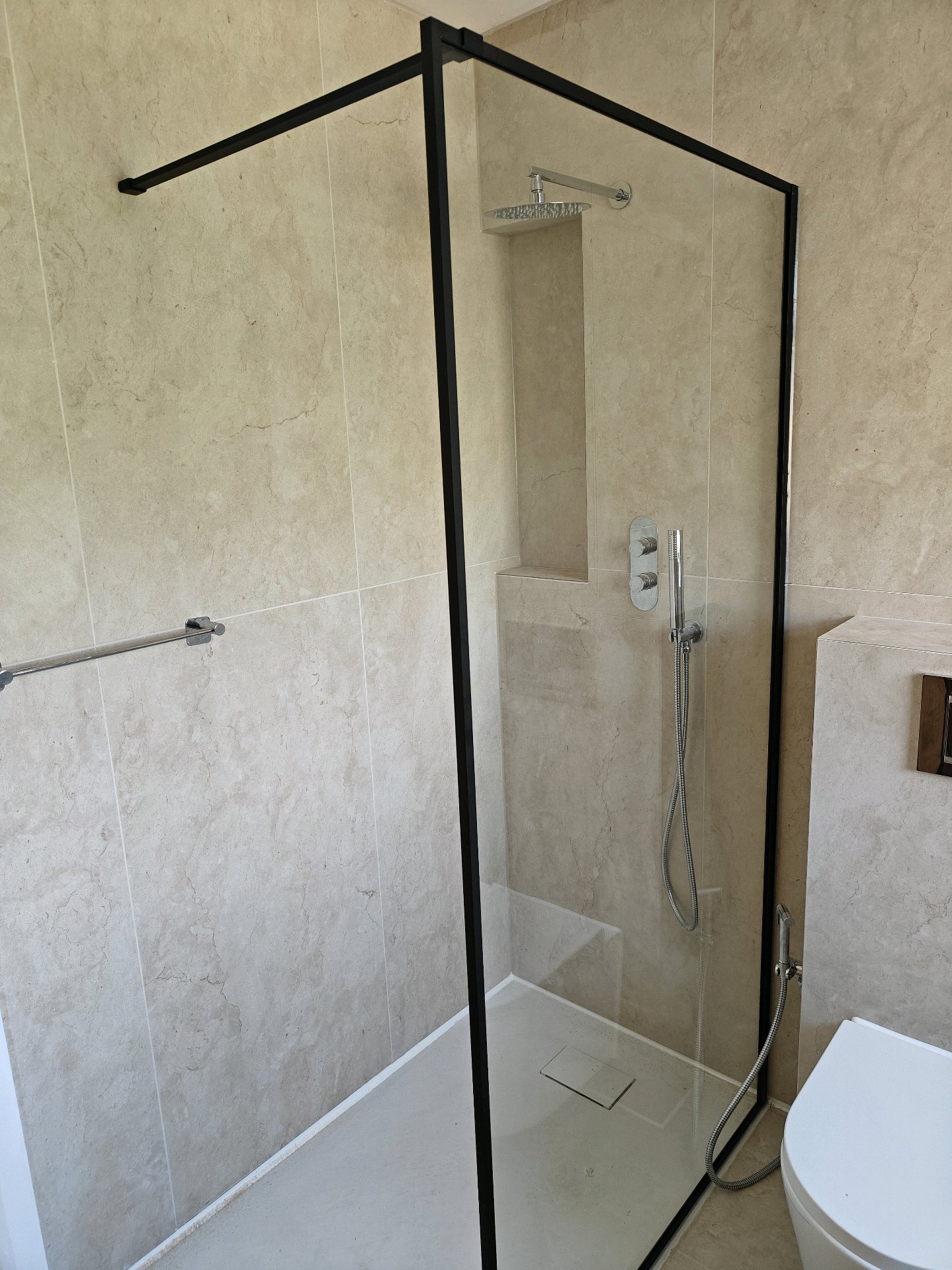 Walk-in shower with black crittall frame, rainfall head and recessed niche